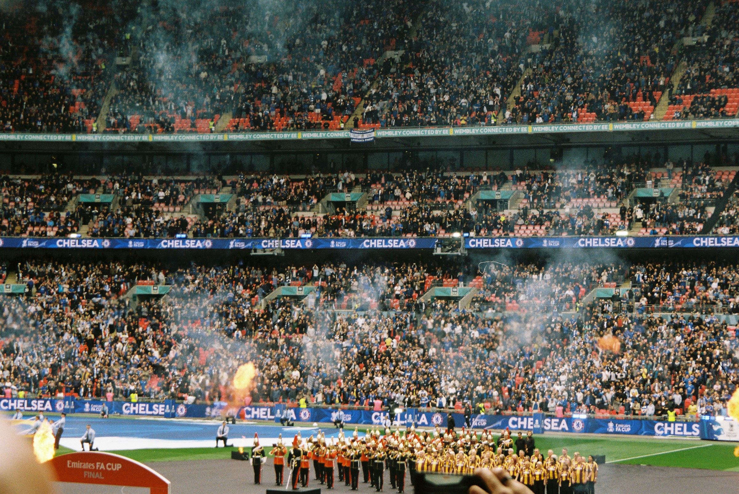 Football supporters celebrating inside a packed stadium